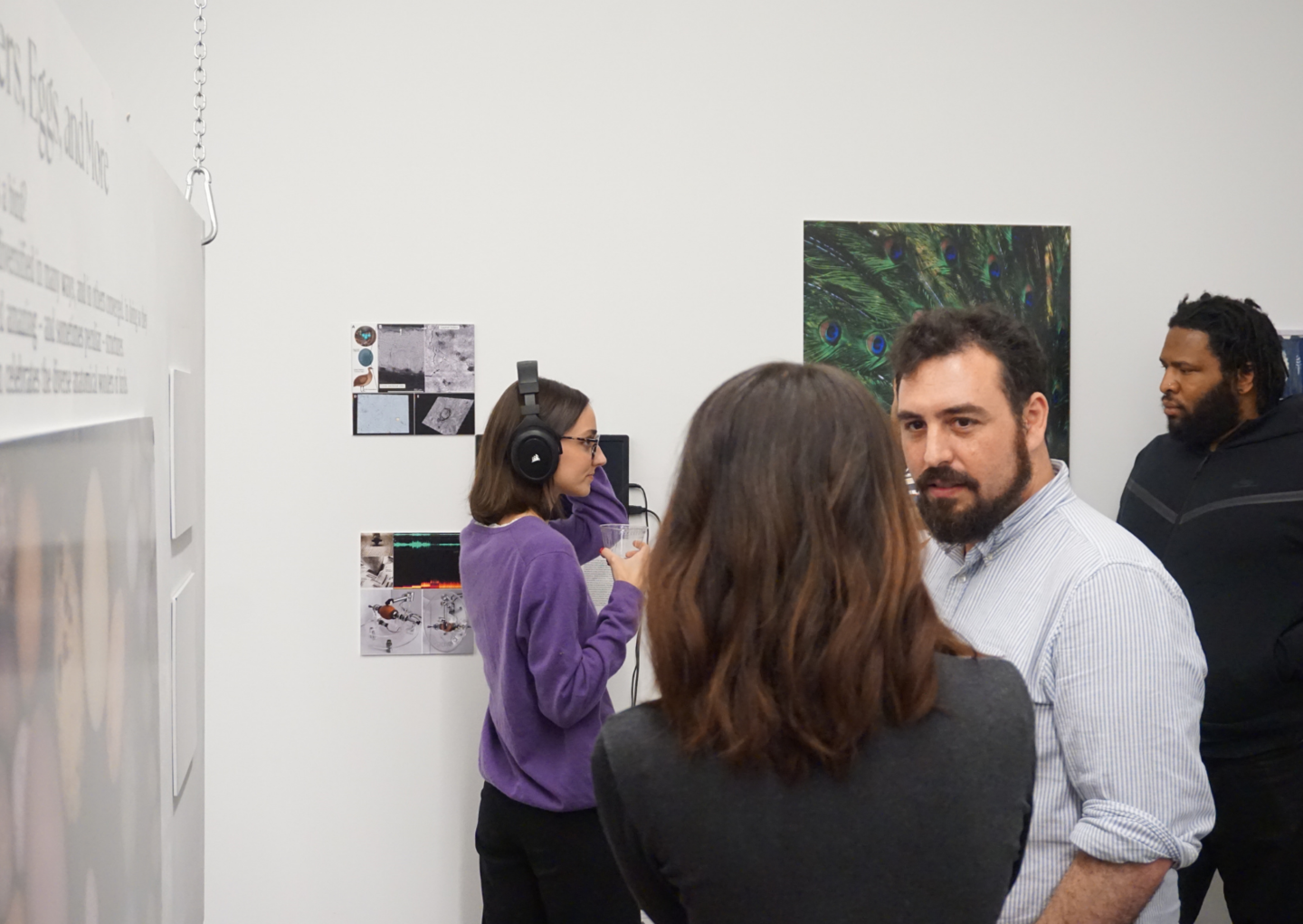people looking at and discussing exhibition art