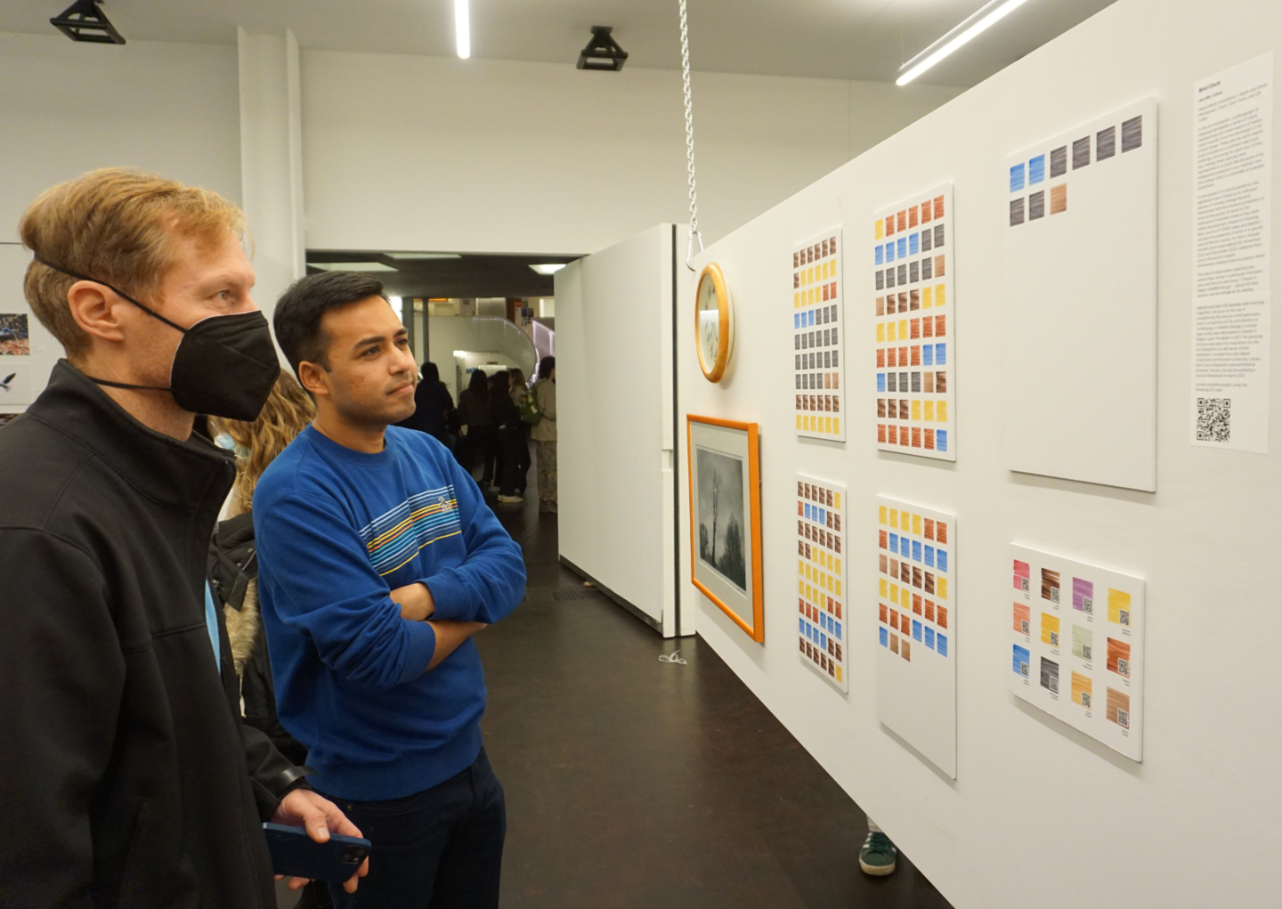 people looking at exhibition art