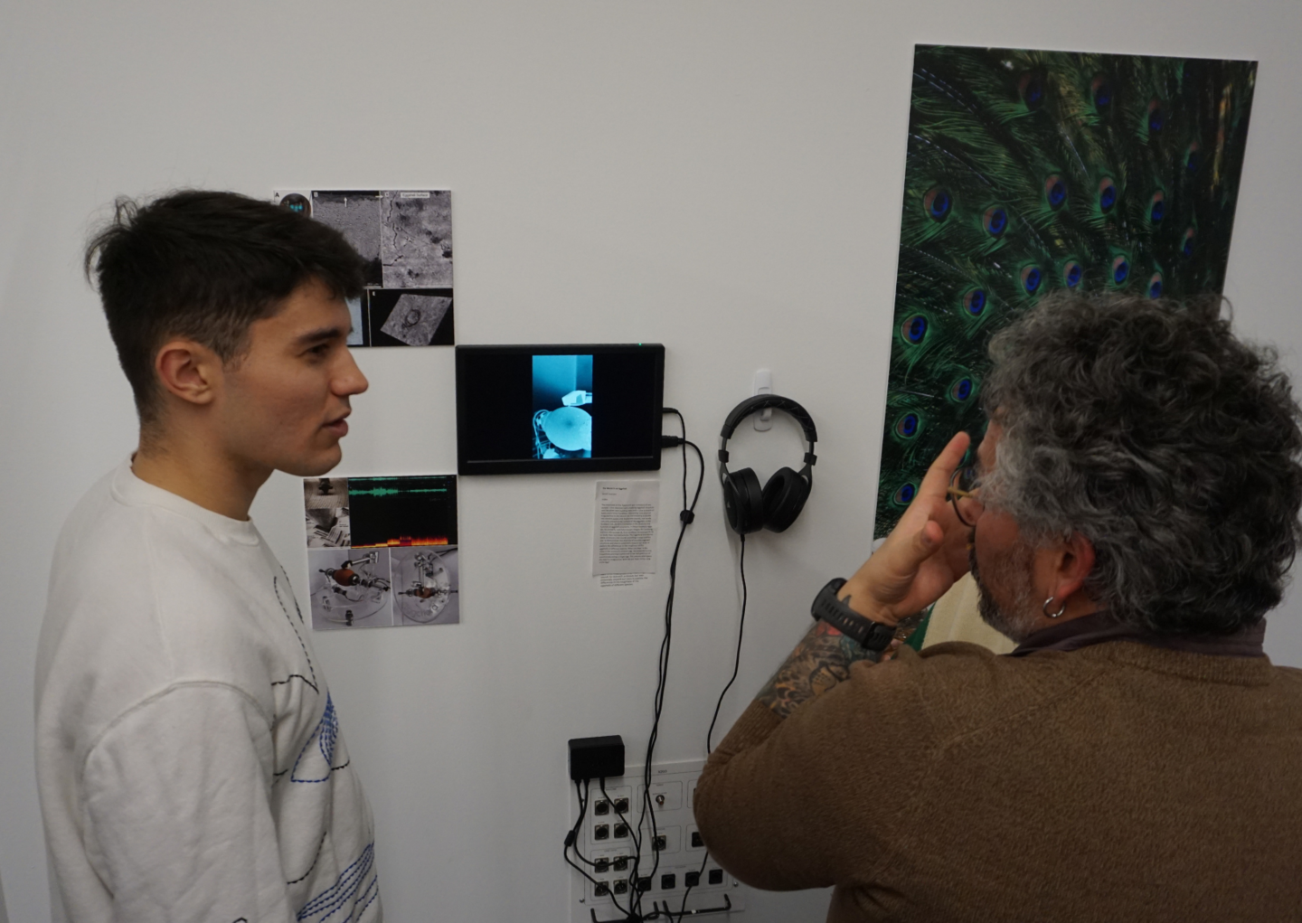 people looking at and discussing exhibition art