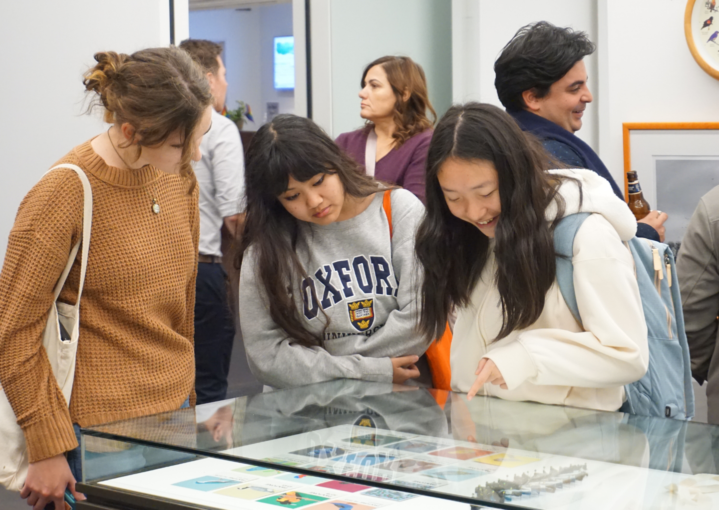 people looking at and discussing exhibition art