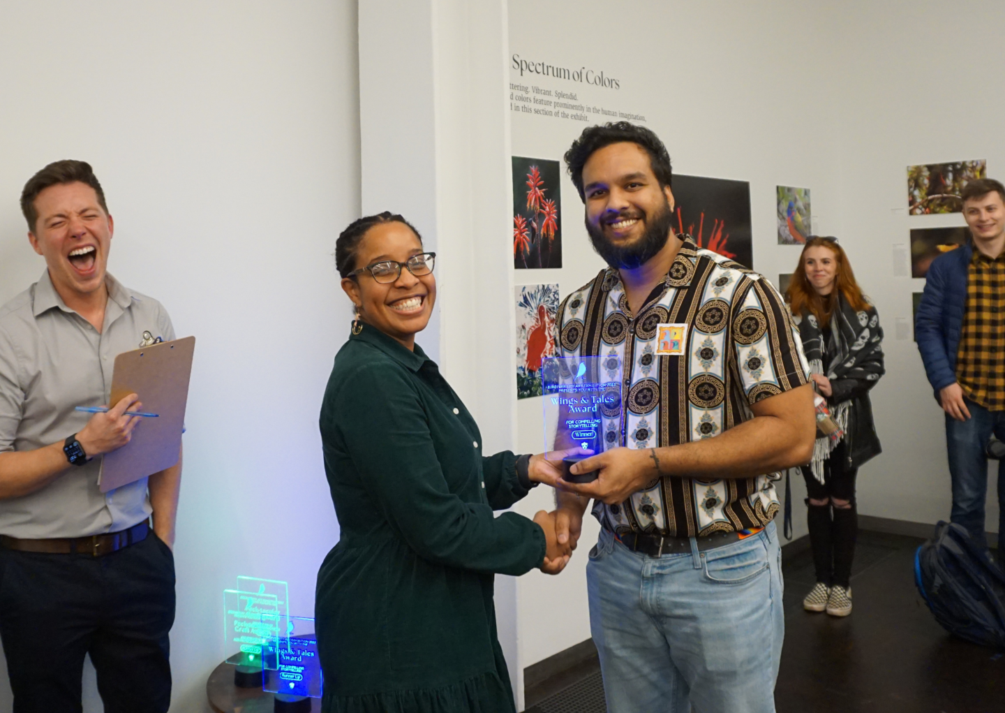 an award recipient receiving their trophy