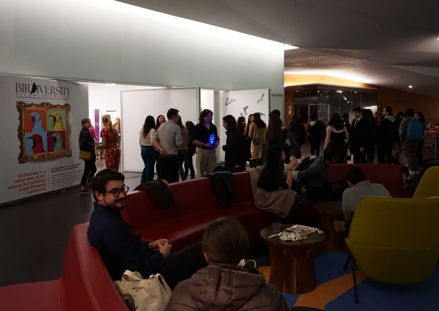 people discussing exhibition art in the lobby of the LCA