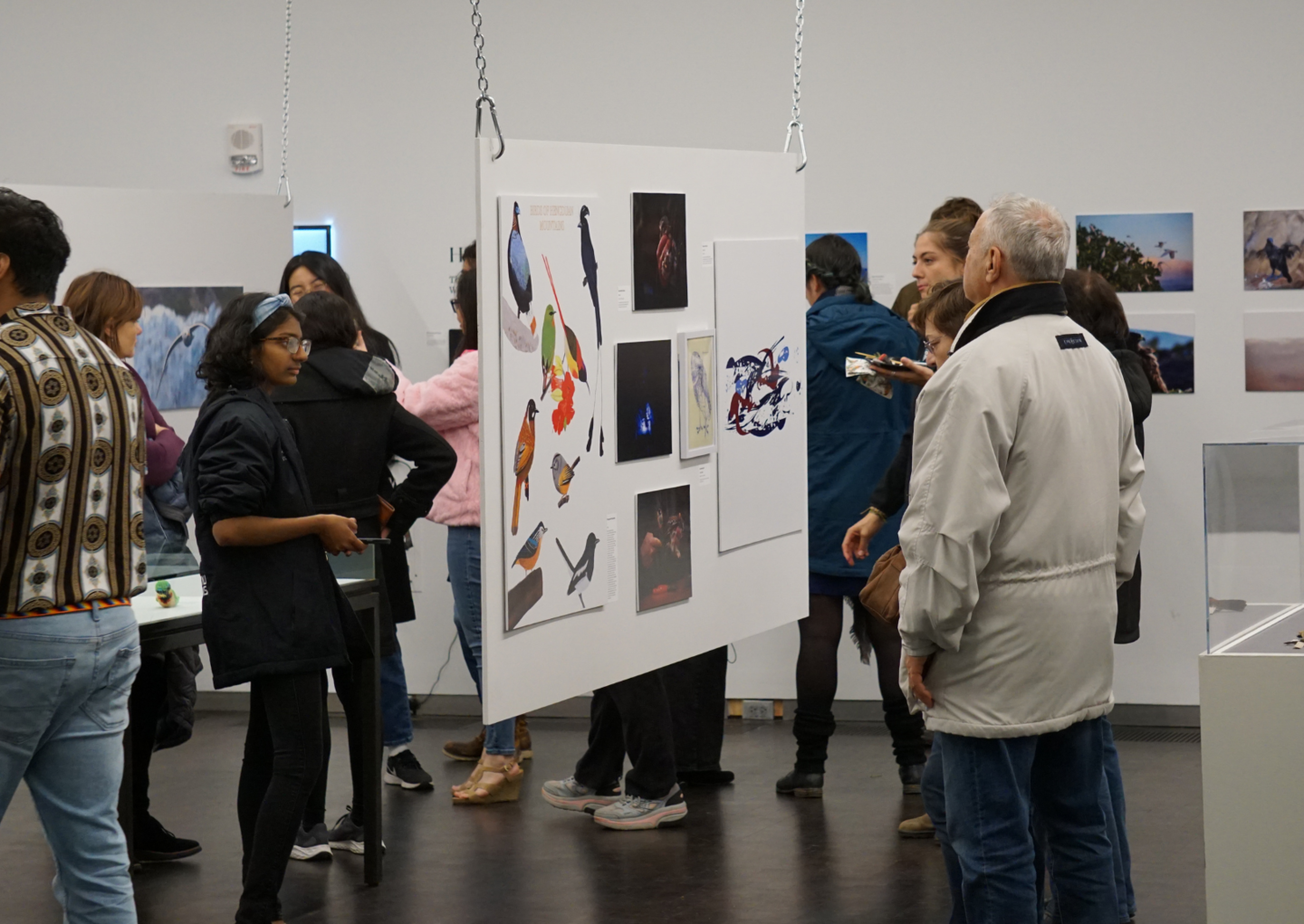 people looking at and discussing exhibition art