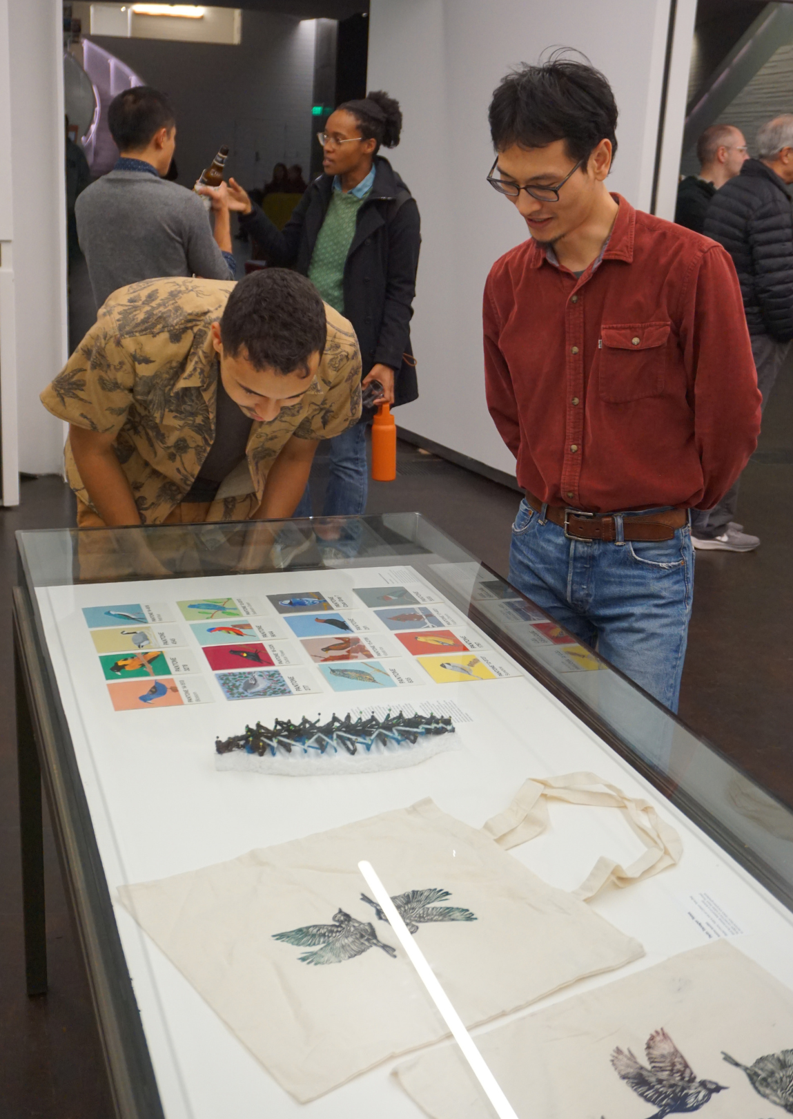 people looking at and discussing exhibition art
