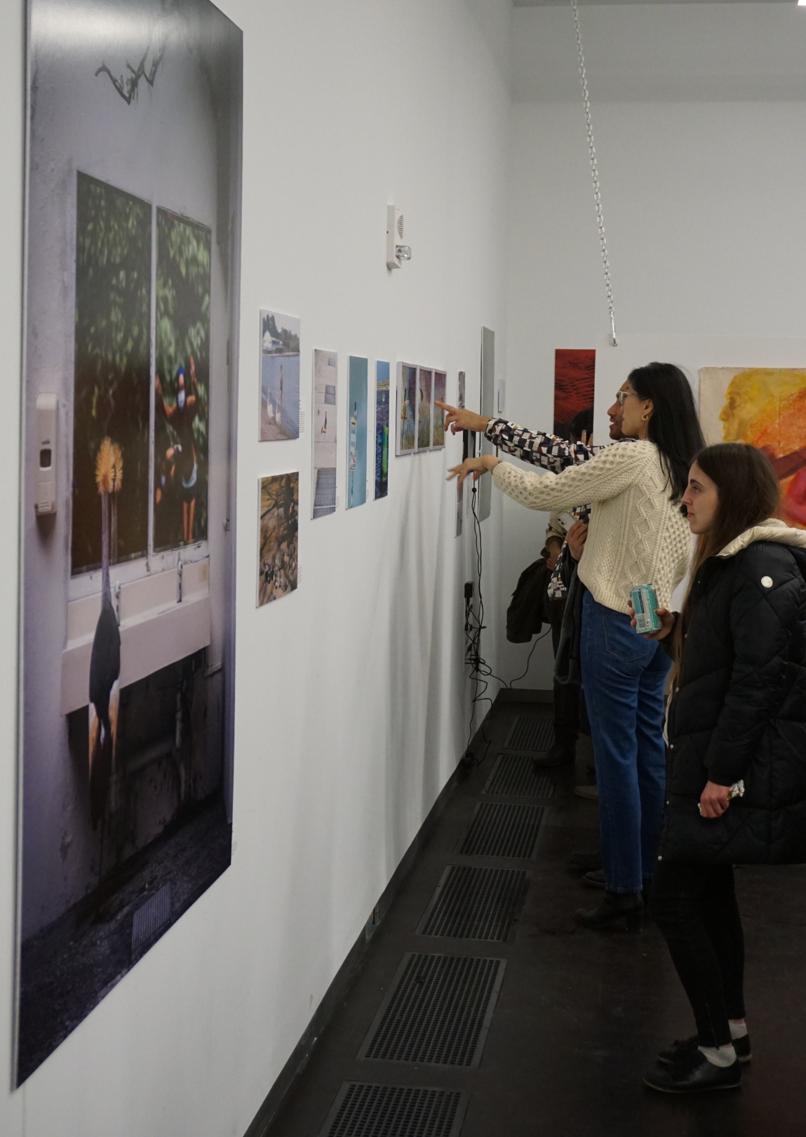 people looking at and discussing exhibition art