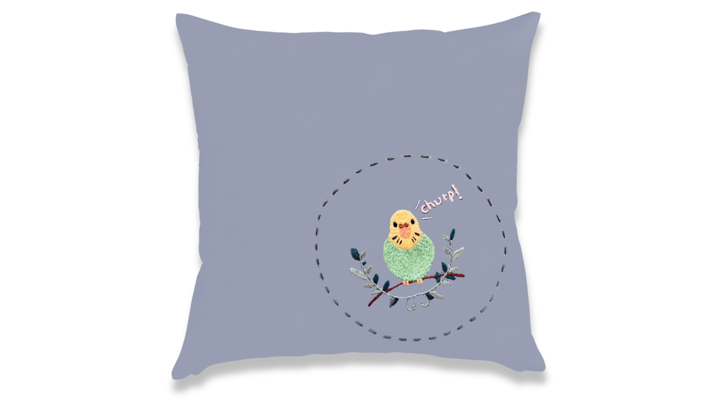 parakeet saying "chirp" embroidered in the corner of a pillowcase