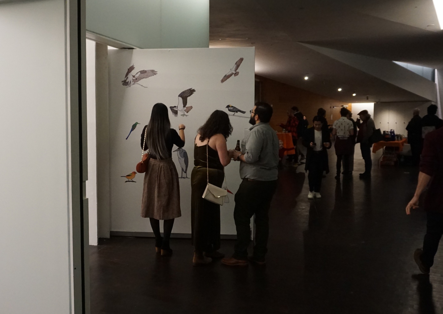 people looking at and discussing exhibition art