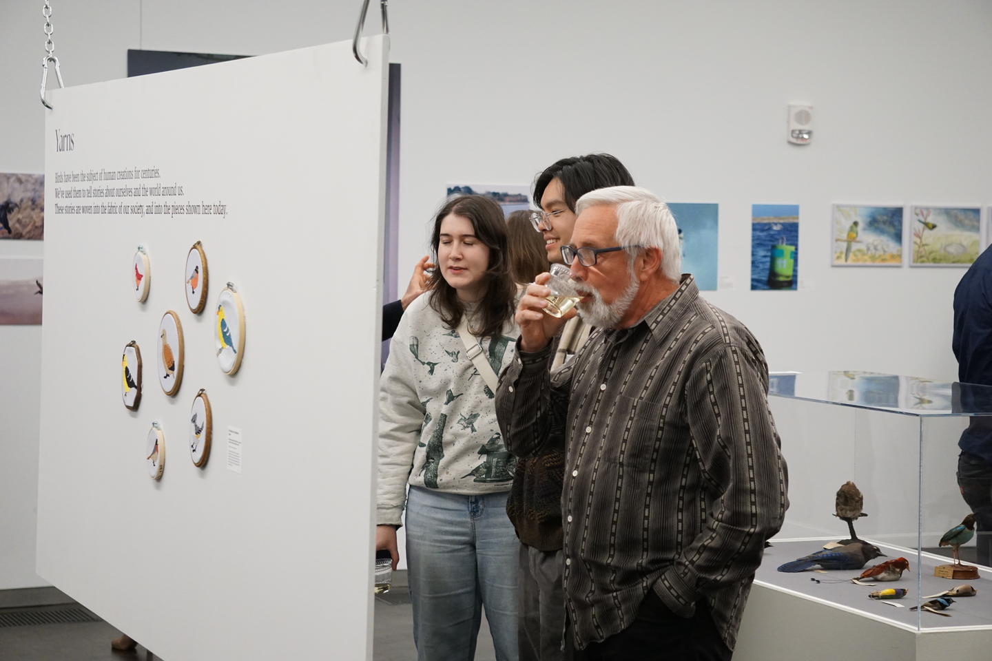 attendees looking at floating wall of art at BirDiversity